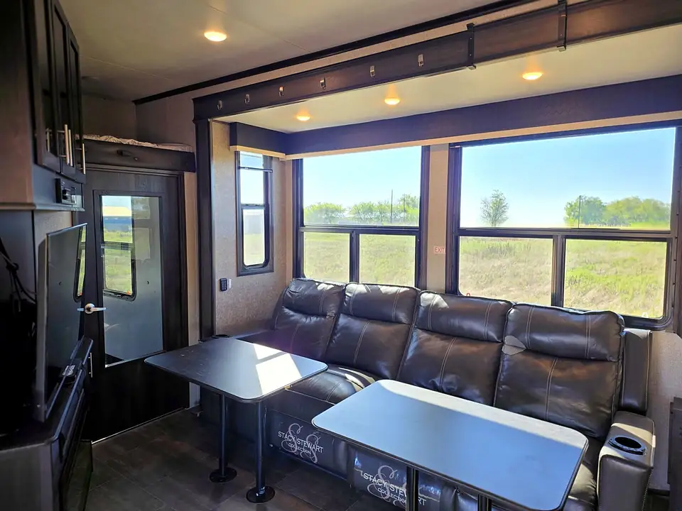 Living room with leather sofa and large windows